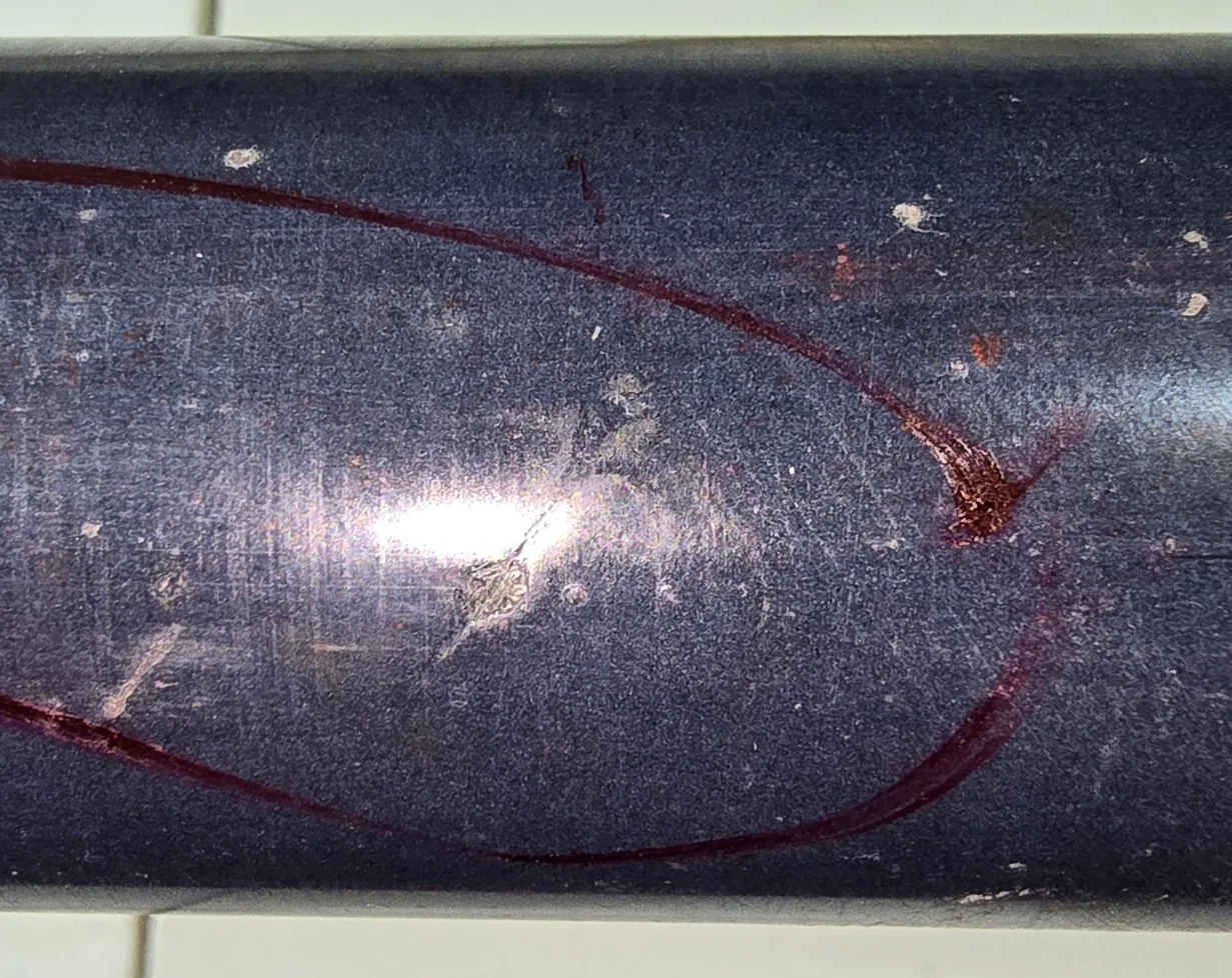 Marked defect area on a carbon-fiber smoothing bar used for repair scope