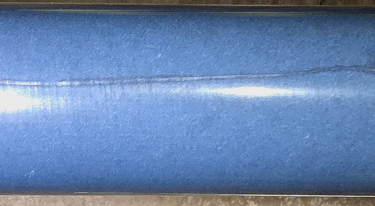 Restored carbon-fiber smoothing bar contact surface after dimensional finishing and coating work