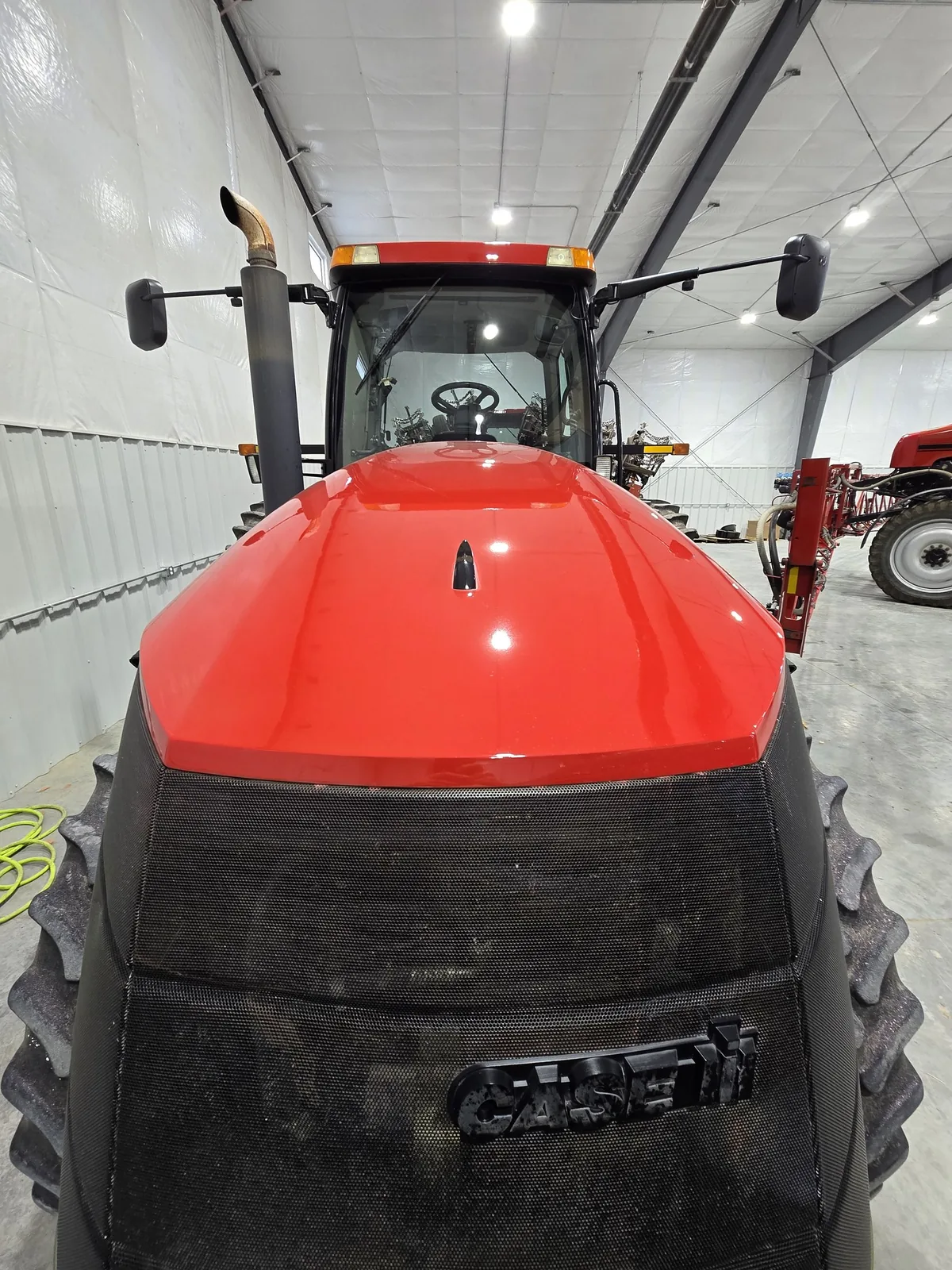Restored red color and gloss on the same Case IH Magnum 275 hood after correction